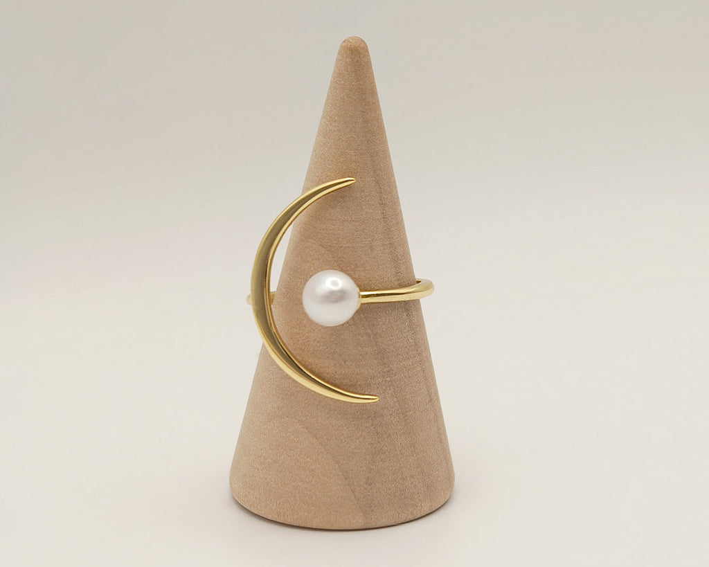 Pearl mounted on a gold adujstable ring in the shape of moon