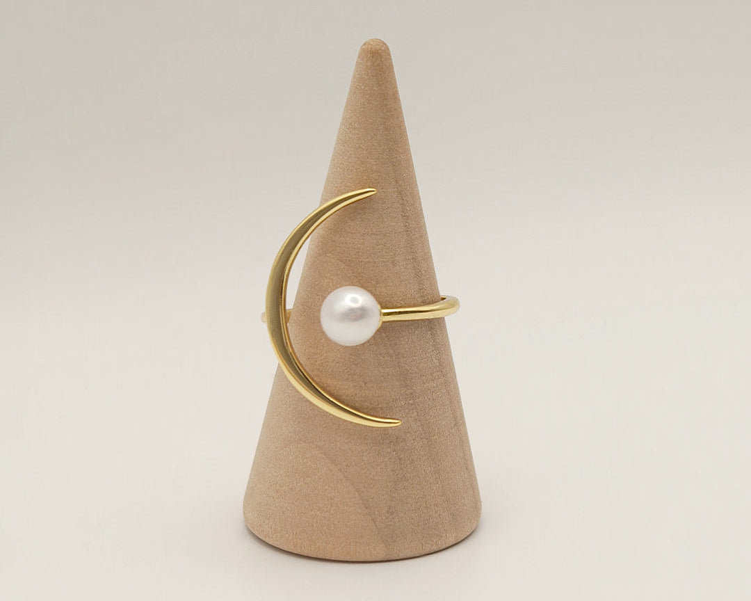 Pearl mounted on a gold adujstable ring in the shape of moon