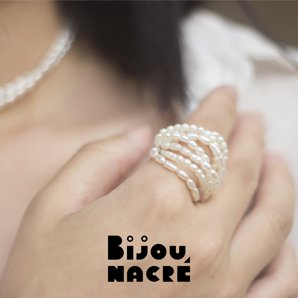 Gold rice baroque pearl ring with milky way design on finger, by Bijou Nacre