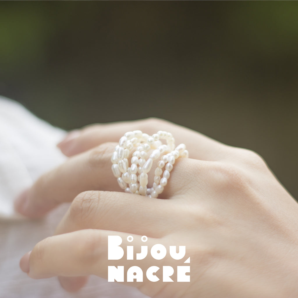Gold rice baroque pearl ring on display surface, milky way design